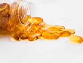spilled bottle of yellow capsule pills